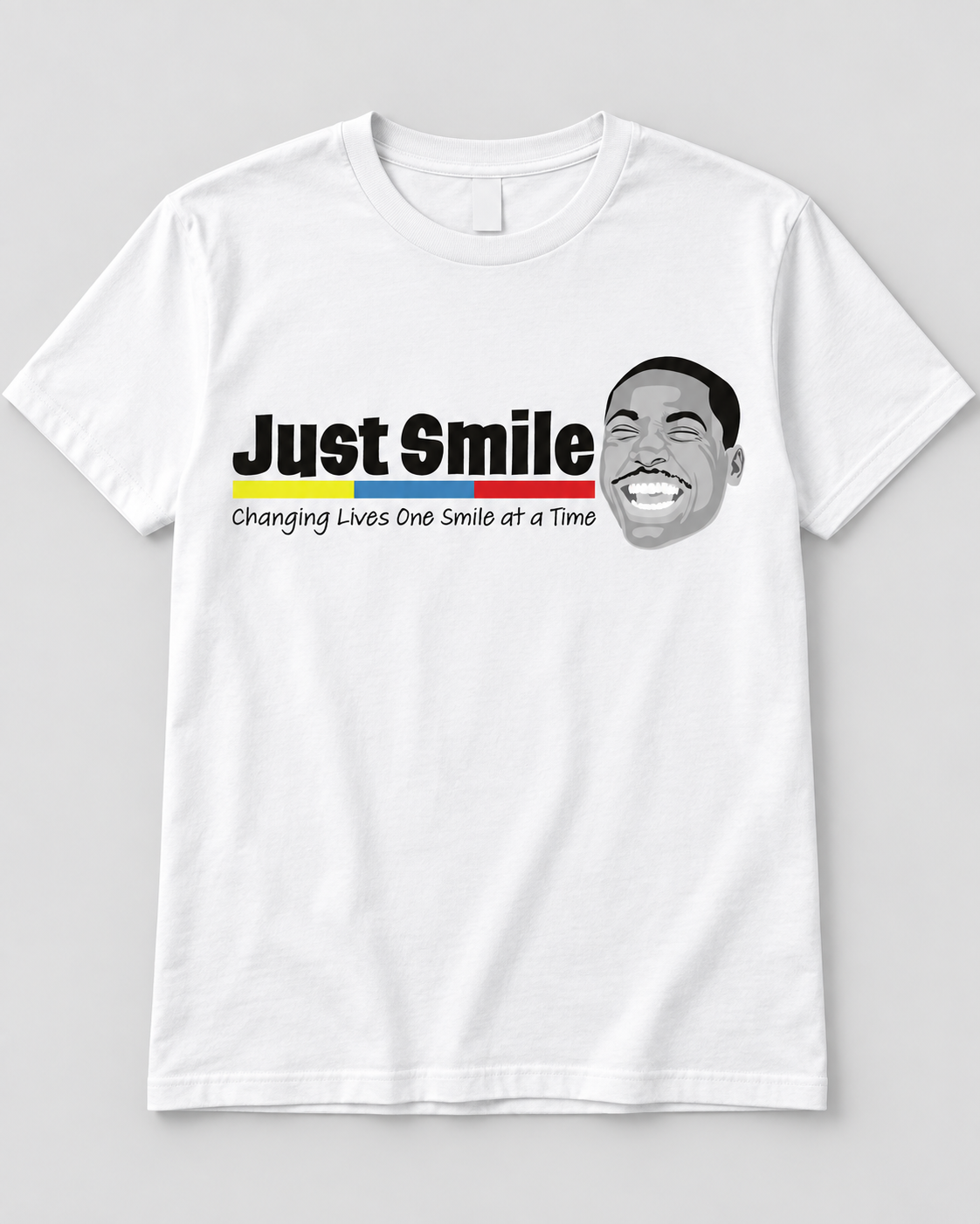 White Just Smile t-shirt with the Just Smile logo and the words Changing Lives One Smile at a Time